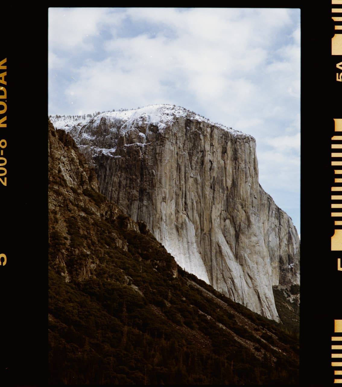 Full-border DSLR scan of a mountain wall, with the film edges visible